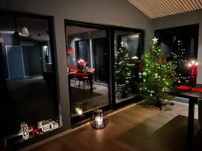 a living room with a christmas tree in a room at Great cottage with unique views and high standard in Tørhogg