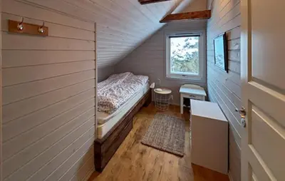 a small bedroom with a bed and a window at Stunning Home In Torangsvåg in Skår