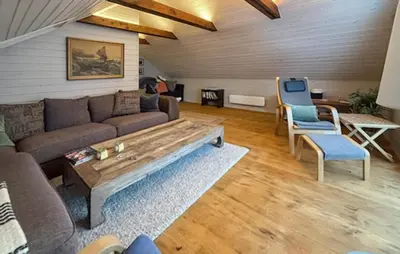a living room with a couch and a table and chairs at Stunning Home In Torangsvåg in Skår