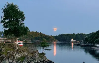 a view of a river with the moon in the sky at Stunning Home In Torangsvåg in Skår