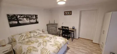 a living room with a couch and a table and a desk at Storgata 36 in Lillehammer
