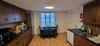 a kitchen with a table and chairs in a room at Storgata 36 in Lillehammer