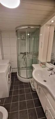 a bathroom with a shower and a sink and a toilet at Storgata 36 in Lillehammer
