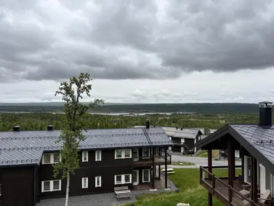 a group of buildings with a tree in the middle at Stor leilighet på Bualie, Golsfjellet in Gol