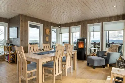 a dining room with a table and chairs at Stor leilighet på Bualie, Golsfjellet in Gol