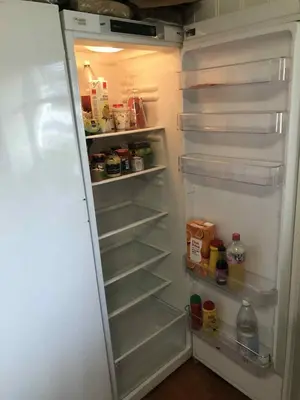 a white refrigerator with its door open with food inside at Trondhjemsvegen in Gjøvik