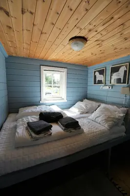 a bed in a blue room with towels on it at Cabin 
