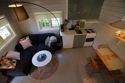 a small living room with a couch and a table at Cabin 
