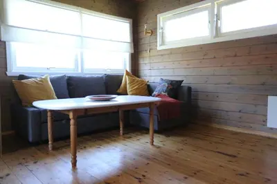 a living room with a couch and a table at Cabin 