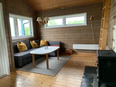 a living room with a couch and a table at Cabin 
