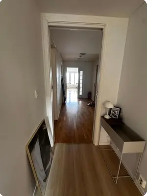 an empty room with a hallway leading to a living room at Apartment in city centre with view of the canal in Trondheim
