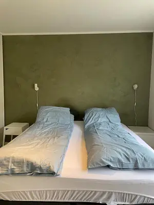 a bed with two pillows on top of it at Bright Modern Apartment - Prime Location in Ålesund