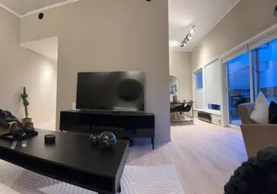 a living room with a large flat screen tv at Modern apartment with stunning view over city in Trondheim