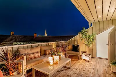 a rooftop patio with a couch and a table at Beautiful house - walking distance of everything in Trondheim