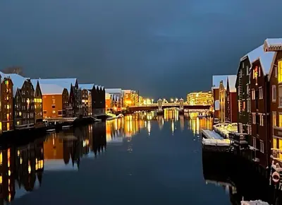 a view of a river with buildings and a bridge at Beautiful house - walking distance of everything in Trondheim