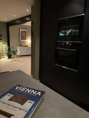 a kitchen with a oven and a magazine on a table at Beautiful house - walking distance of everything in Trondheim