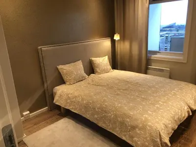 a bedroom with a bed with two pillows on it at Unique City Center 3-rooms panoramic view with free parking in Trondheim