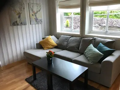 a living room with a couch and a coffee table at Bright and nice apartment in Trondheim
