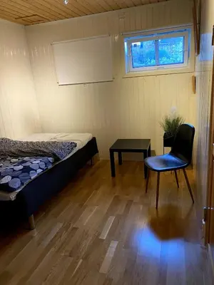 a room with a bed and a chair and a table at Large single-family home for rent World Cup 2025 in Trondheim