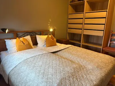 a bedroom with a large bed with yellow pillows at Perfectly Located-Close To Ski Slopes And Hiking Trails in Beitostøl