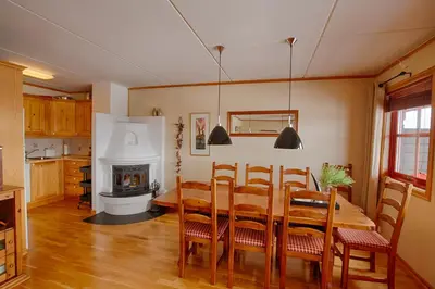 a dining room with a table and a fireplace at Perfectly Located-Close To Ski Slopes And Hiking Trails in Beitostøl
