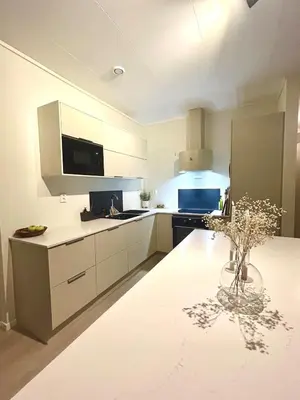 a large kitchen with white cabinets and a table at Kolsåsbakken, Granåsen, Nordic Ski World Championships in Trondheim