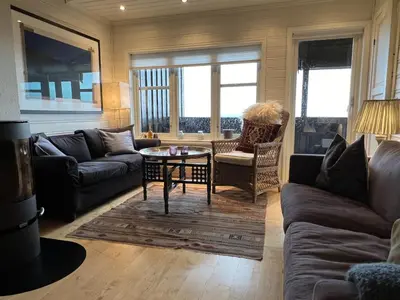 a living room with a couch and a table at Stylish 4-Bedroom Apartment With Mountain Views! in Beitostøl