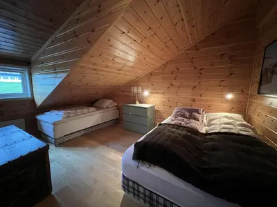 a room with two beds in a wooden cabin at Stylish 4-Bedroom Apartment With Mountain Views! in Beitostøl