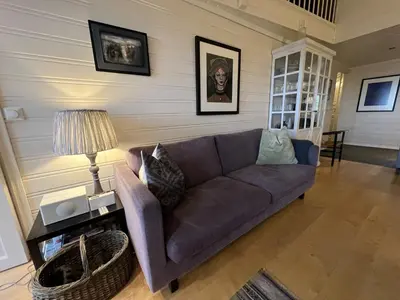 a living room with a couch and a table at Stylish 4-Bedroom Apartment With Mountain Views! in Beitostøl