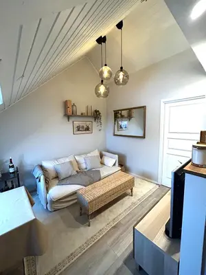 a living room with a couch and a table at City View, stylish loft apartment and Central Location in Trondheim