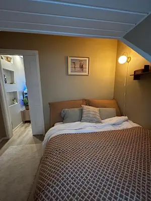 a bedroom with a large bed in a room at City View, stylish loft apartment and Central Location in Trondheim