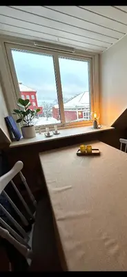 a room with a desk and a window with a plant at City View, stylish loft apartment and Central Location in Trondheim