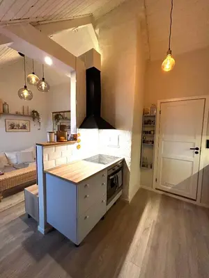 a kitchen with a counter and a stove top oven at City View, stylish loft apartment and Central Location in Trondheim