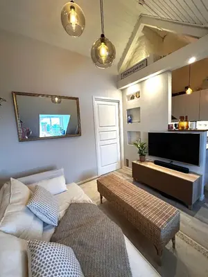 a living room with a flat screen tv on the wall at City View, stylish loft apartment and Central Location in Trondheim