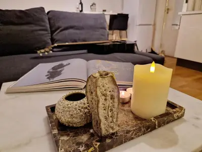 a table with a candle and an open book at Cozy condo near Bryggen Full kitchen Elevator in Bergen