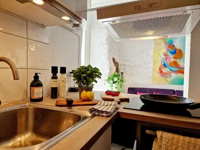 a kitchen with a sink and a counter top at Beautiful condo near Bryggen Balcony Fireplace in Bergen