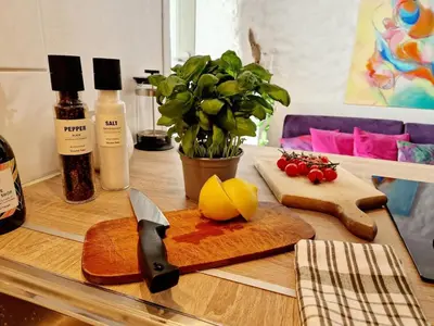 a table with a cutting board with a knife and vegetables at Beautiful condo near Bryggen Balcony Fireplace in Bergen