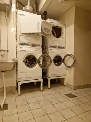 two washing machines and a microwave in a kitchen at Sleep well in Heart of Bergen - Beautiful street in Bergen