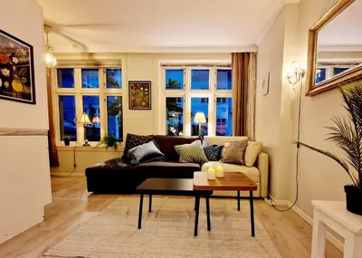 a living room with a couch and a table at Sleep well in Heart of Bergen - Beautiful street in Bergen