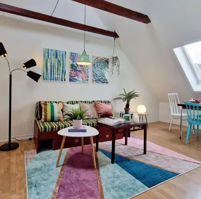 a living room with a couch and a table at Top Floor Close to Grieg Hall and Town Square in Bergen