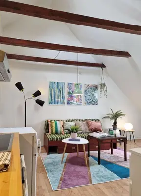 a living room with a couch and a table at Top Floor Close to Grieg Hall and Town Square in Bergen