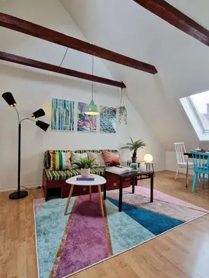 a living room with a couch and a table at Top Floor Close to Grieg Hall and Town Square in Bergen