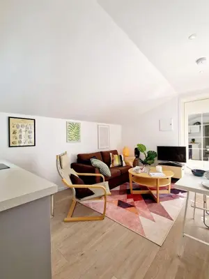 a living room with a couch and a table at City center Terrace in quiet backyard - Stylish in Bergen