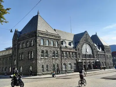 a large building with people riding bikes in front of it at City center Terrace in quiet backyard - Stylish in Bergen