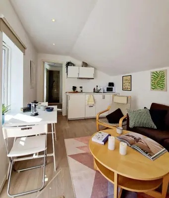 a living room with a couch and a table at City center Terrace in quiet backyard - Stylish in Bergen