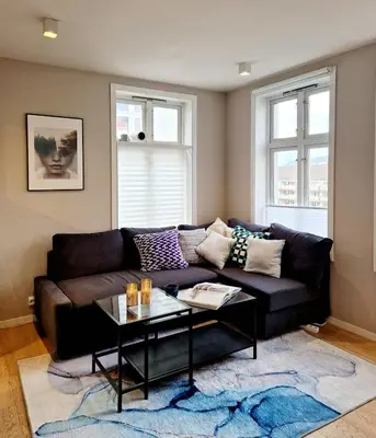 a living room with a couch and a coffee table at Sleep well in Cozy hideout - Bryggen across the bay in Bergen