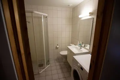 a bathroom with a toilet and a sink and a shower at Central Stay With Balcony, Ideal For Small Family in Beitostøl