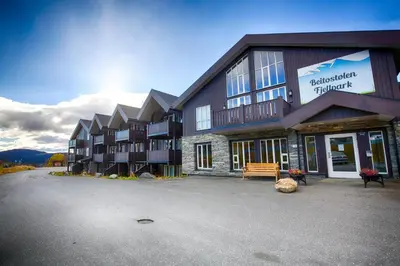 a large building with a bench in front of it at Central Stay With Balcony, Ideal For Small Family in Beitostøl
