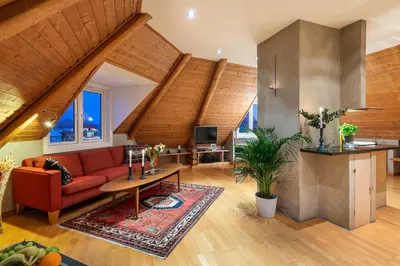 a living room with a red couch and a table at Cozy downtown apartment in Trondheim