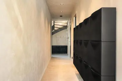 a hallway with a black refrigerator in a room at Bryggen Penthouse I NEW 2021 in Bergen